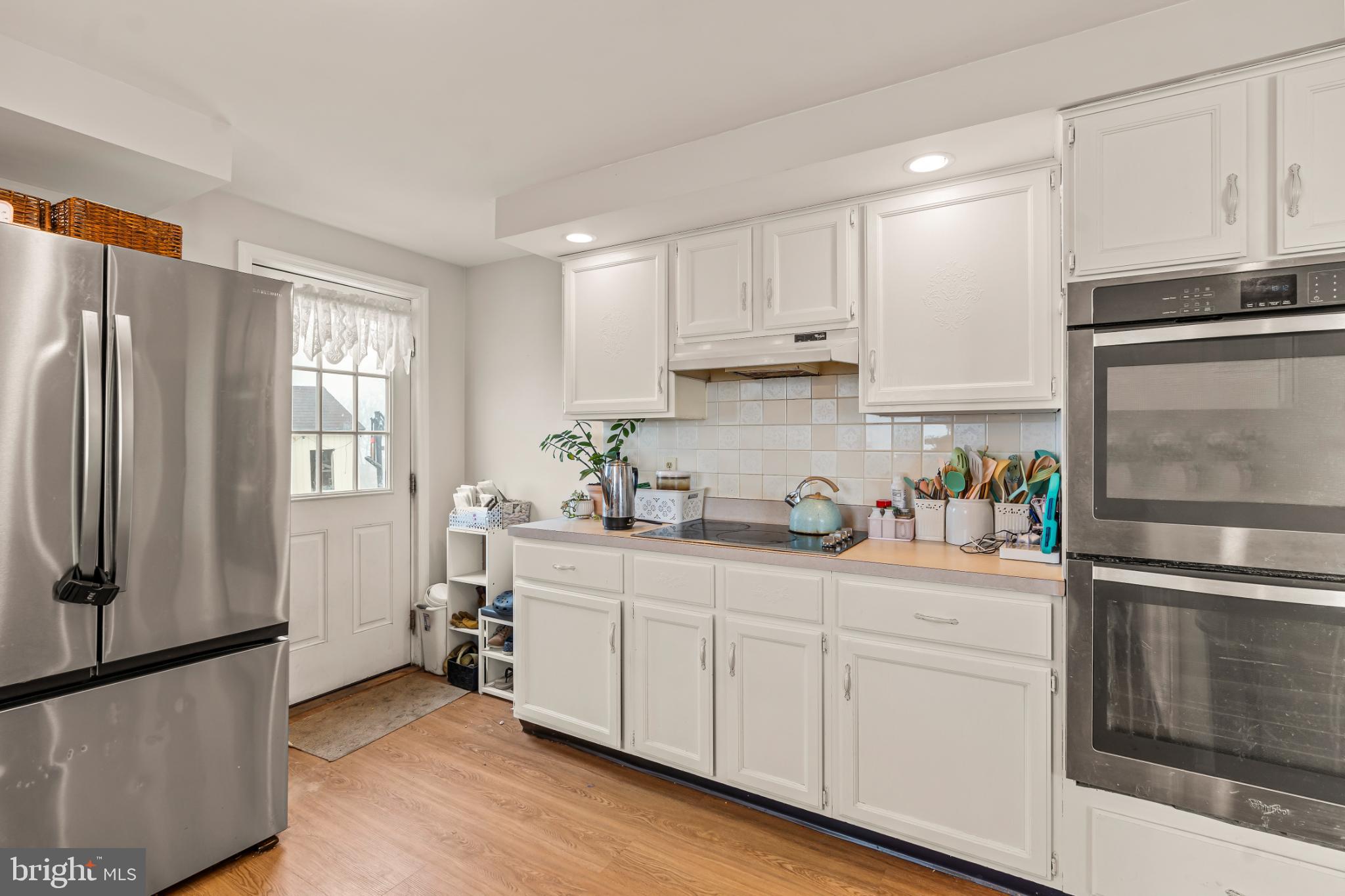 94 Tulip Court Falling Waters, WV 25419 - Photo 13 of 32 a kitchen with stainless steel appliances a refrigerator sink and cabinets
