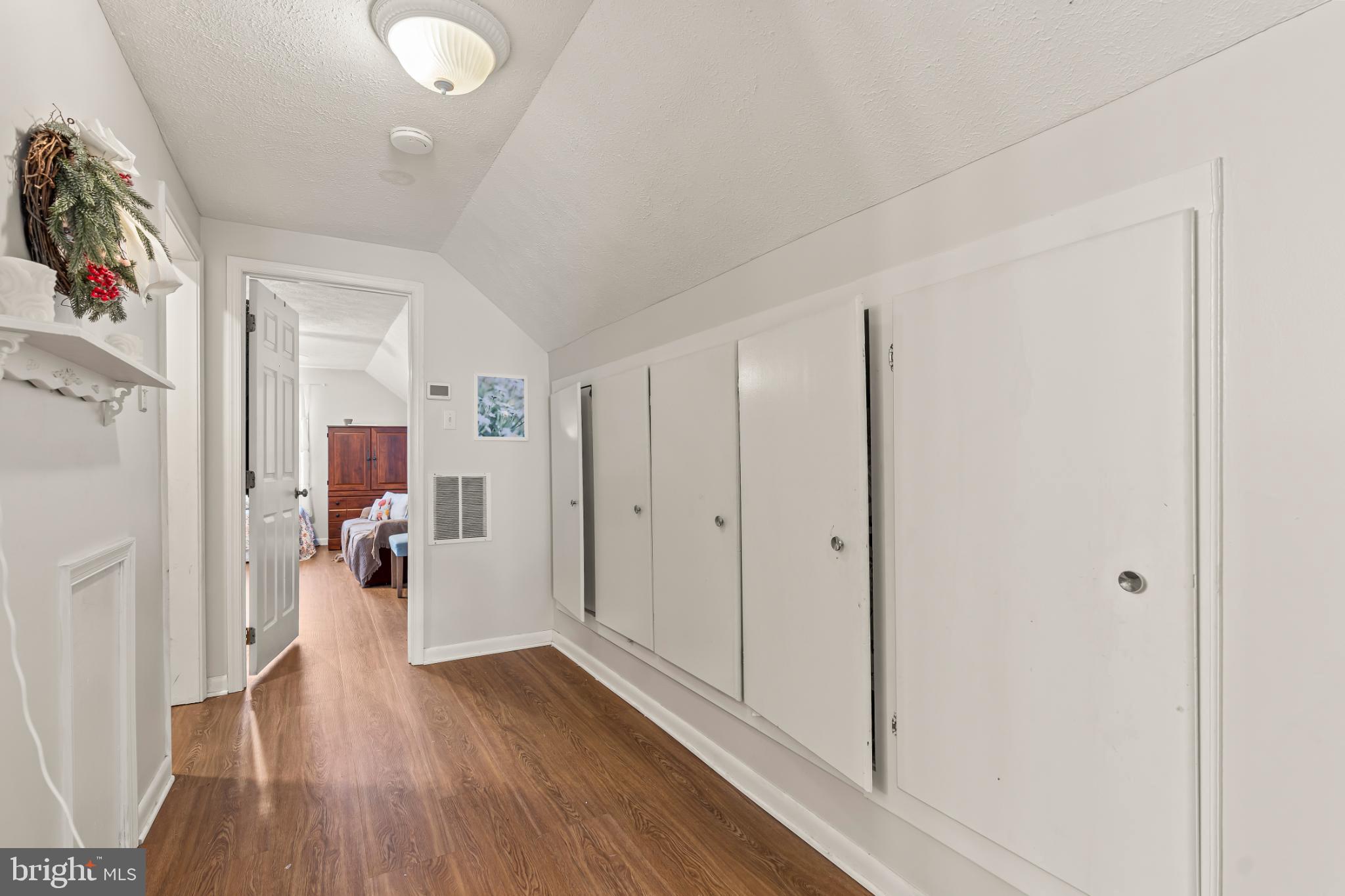 94 Tulip Court Falling Waters, WV 25419 - Photo 22 of 32 a view of a hallway with wooden floor and closet area