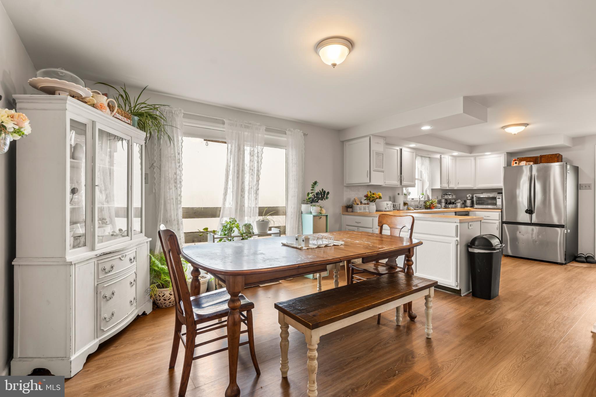 94 Tulip Court Falling Waters, WV 25419 - Photo 6 of 32 a kitchen with a table chairs refrigerator and window