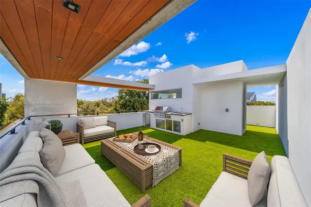 a living room with furniture a rug and a large window