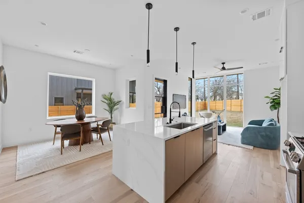 a living room with furniture a dining table and chairs with wooden floor