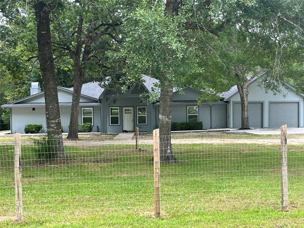 a view of a house with pool and a large tree