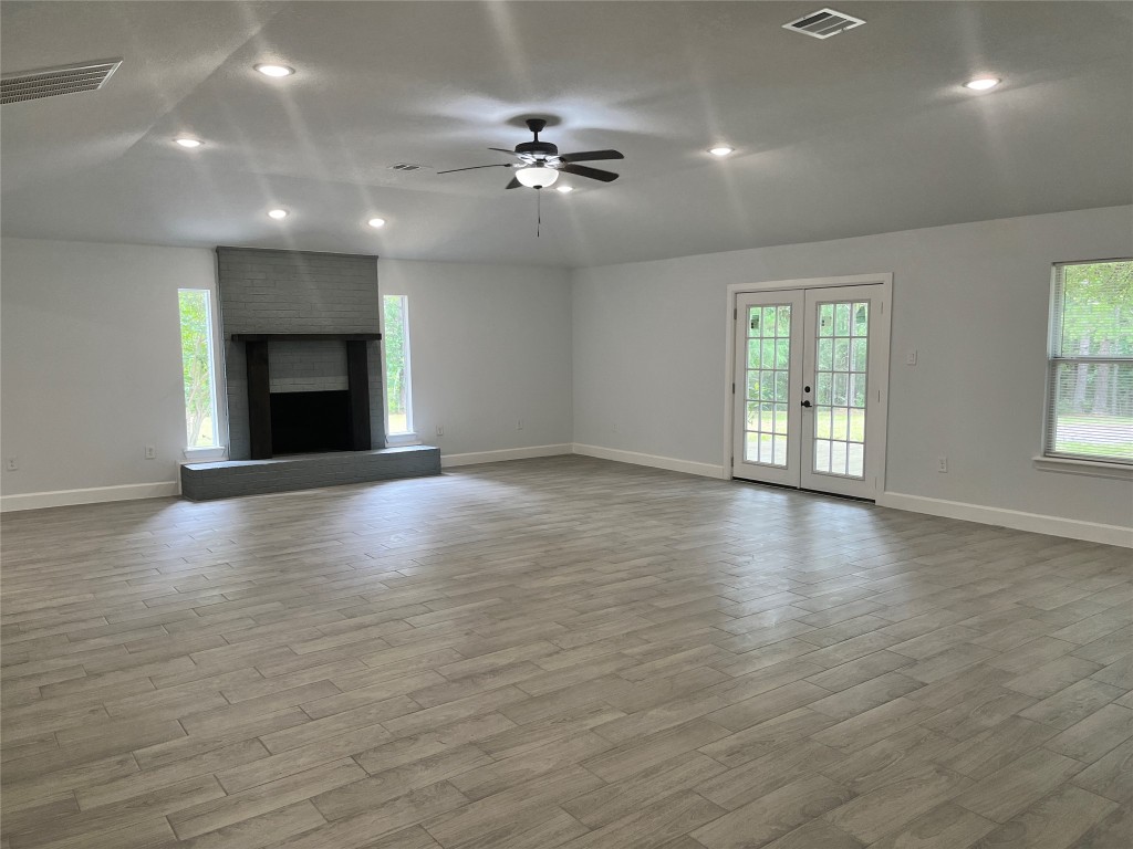 482 Rolling Livingston, TX 77351 - Photo 11 of 41 an empty room with wooden floor and chandelier fan