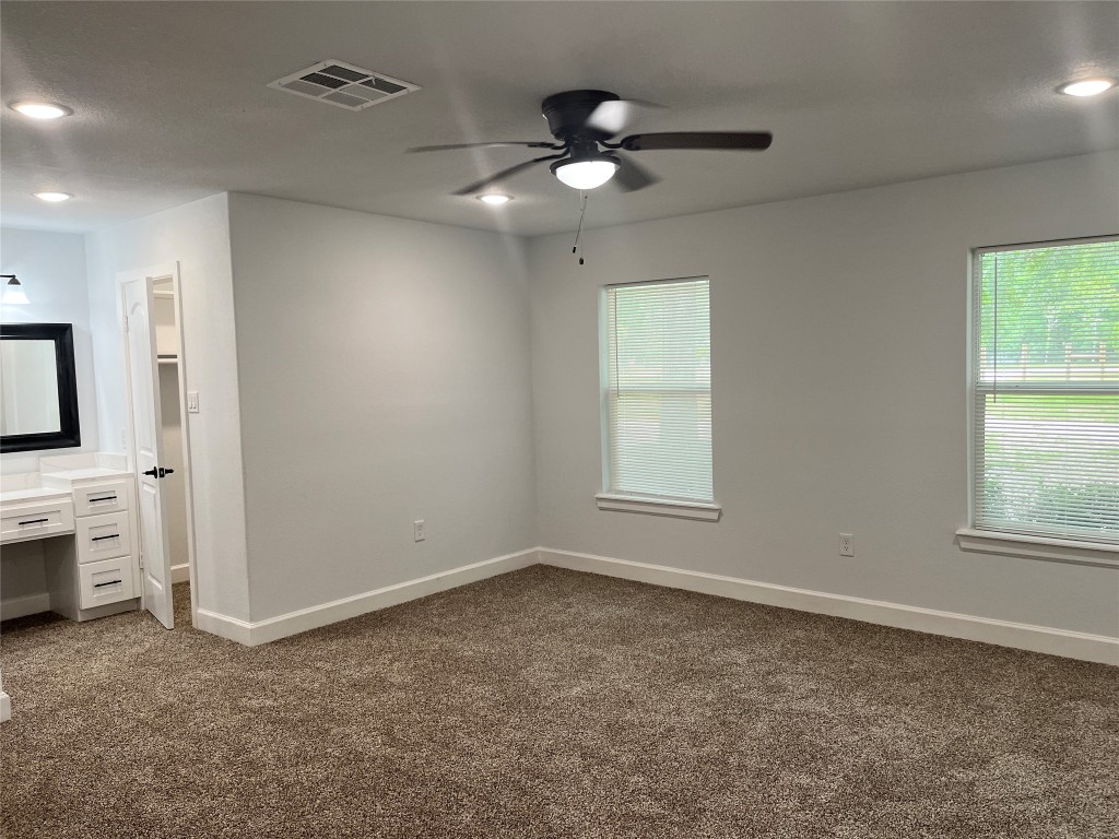 482 Rolling Livingston, TX 77351 - Photo 15 of 41 en empty room with windows and ceiling fan