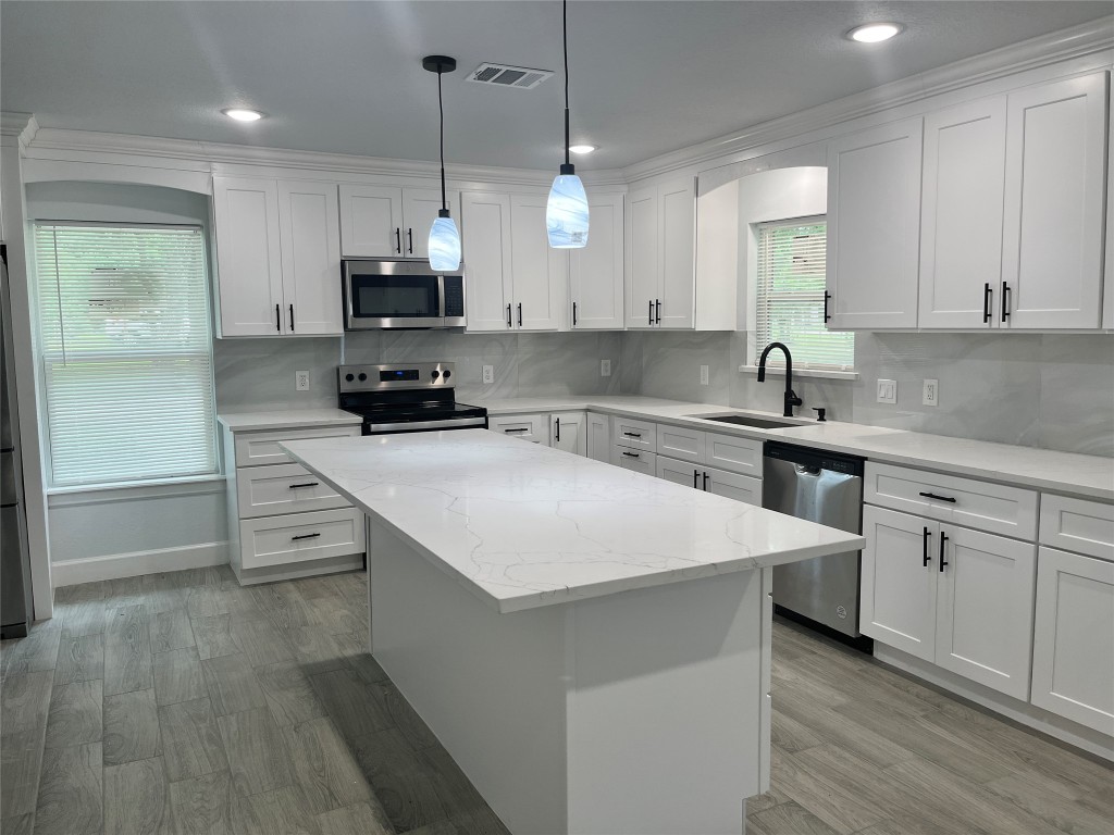 482 Rolling Livingston, TX 77351 - Photo 26 of 41 a kitchen with white cabinets appliances and a window