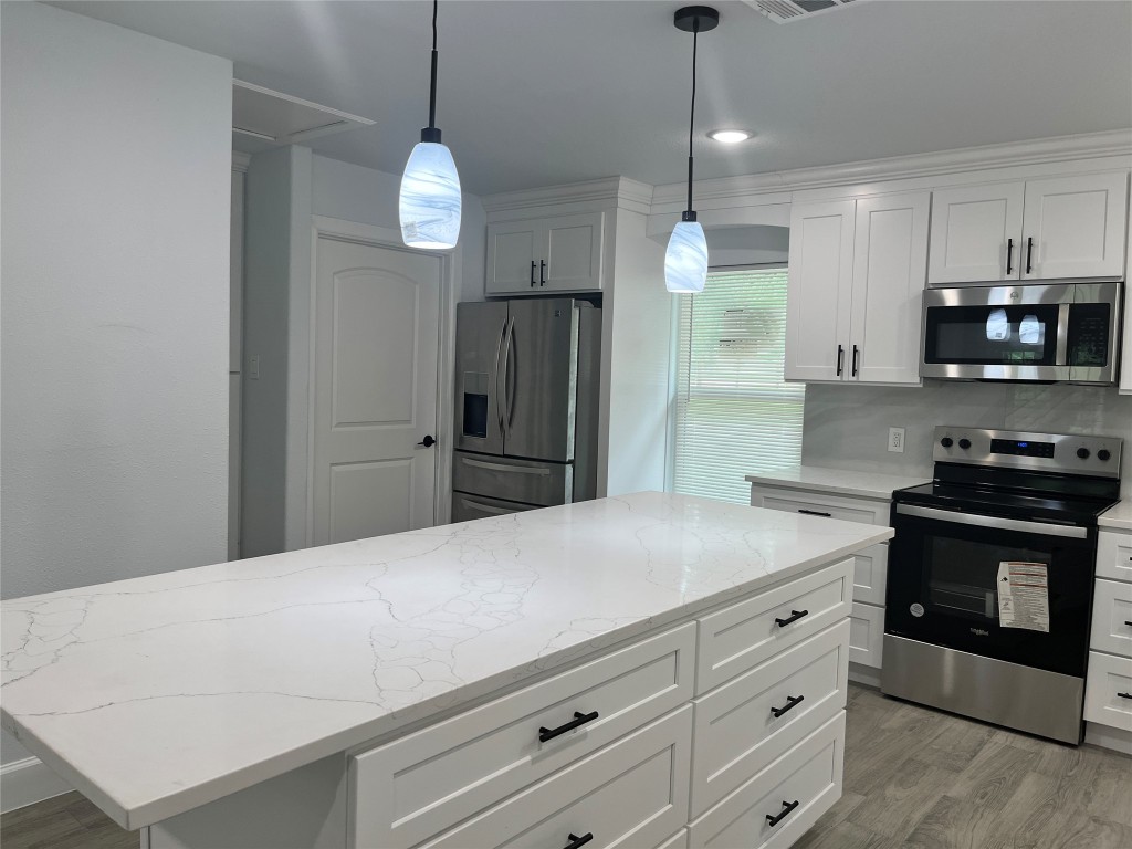 482 Rolling Livingston, TX 77351 - Photo 28 of 41 a kitchen with a refrigerator and a stove top oven
