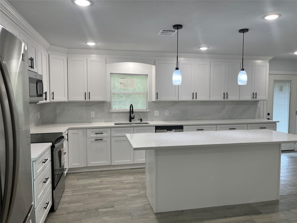 482 Rolling Livingston, TX 77351 - Photo 30 of 41 a kitchen with stainless steel appliances granite countertop a sink a stove and a refrigerator