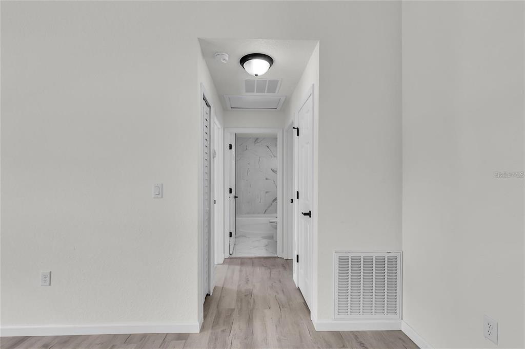 3401 Northeast 16th Court Ocala, FL 34479 - Photo 26 of 27 a view of a hallway with wooden floor