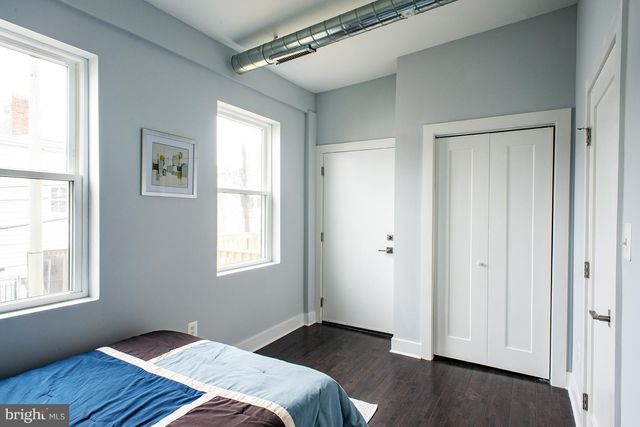 a bedroom with bed and window