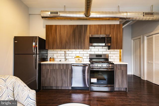 a kitchen with a stove and a refrigerator