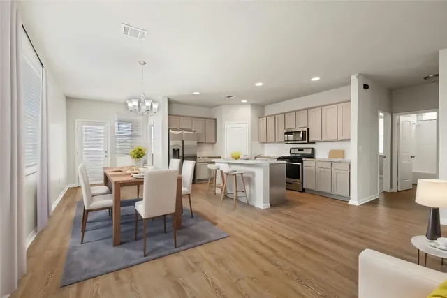 a view of kitchen with refrigerator and wooden floor