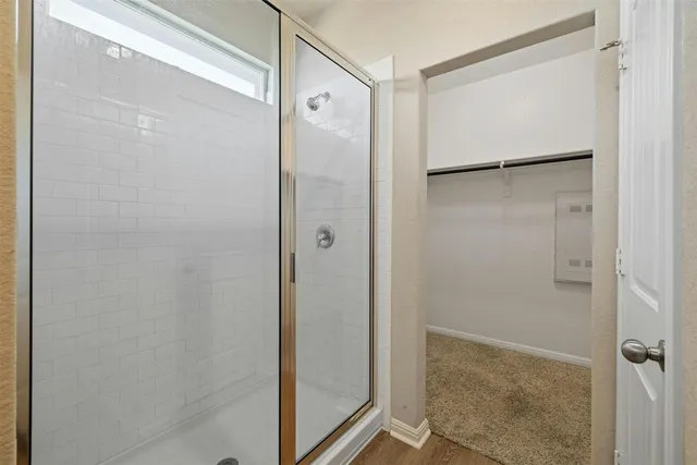 a bathroom with a glass shower door