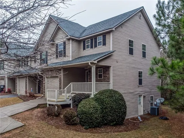 a front view of a house with garden