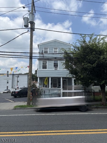 a front view of a house with a garden and plants