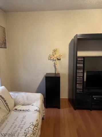 a bedroom with a bed and dresser with mirror