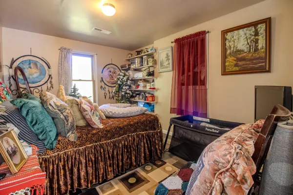 a bedroom with a bed and a chandelier