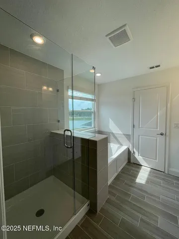 a bathroom with a bathtub and a shower