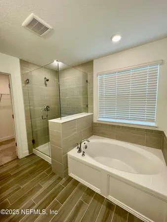 a spacious bathroom with sink shower and bathtub