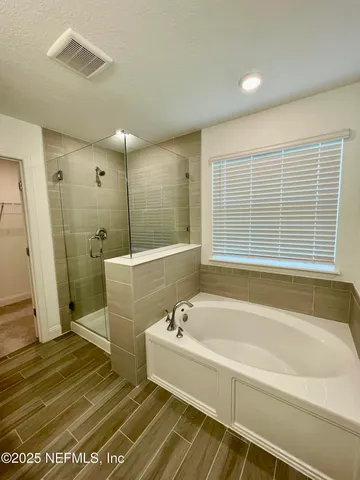 a spacious bathroom with sink shower and bathtub