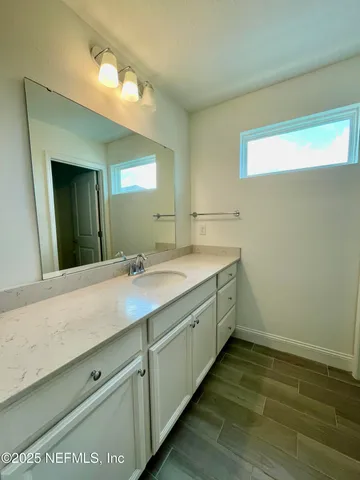 a bathroom with a double vanity sink and a mirror