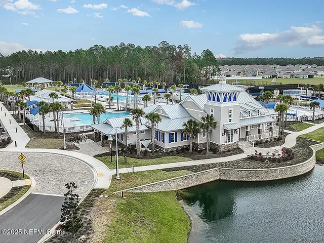 a view of a swimming pool with outdoor seating