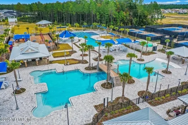 a view of backyard of swimming pool and outdoor seating