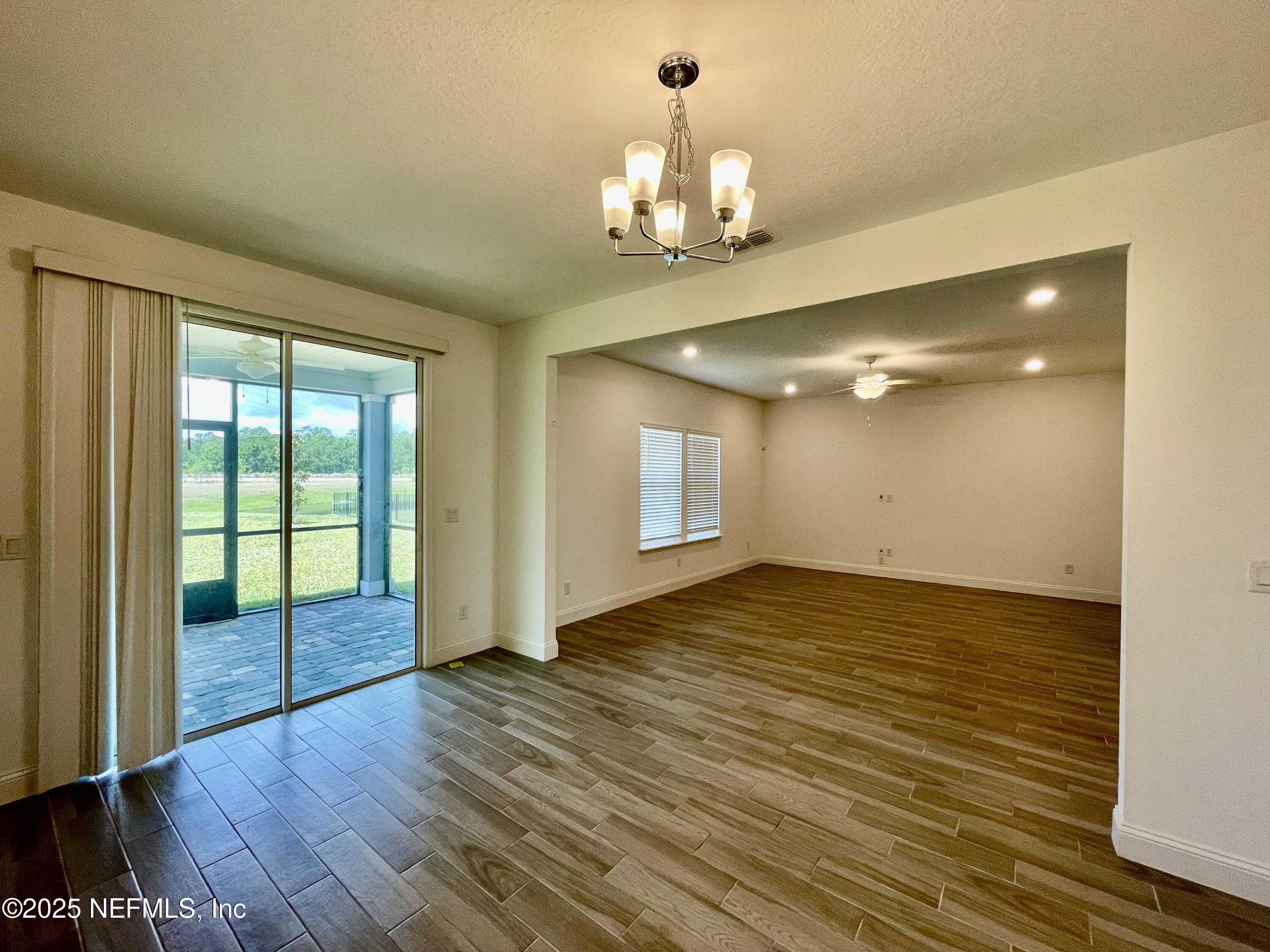 134 Varner Way St. Augustine, FL 32092 - Photo 9 of 30 a view of an empty room with wooden floor and a window