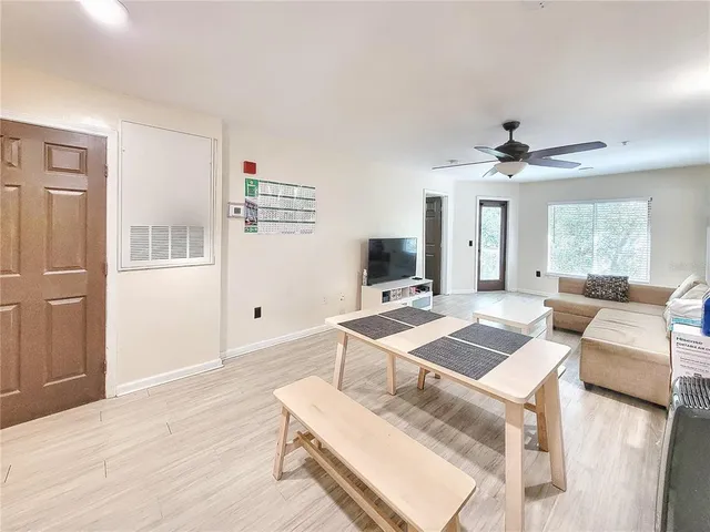 a living room with furniture and a wooden floor