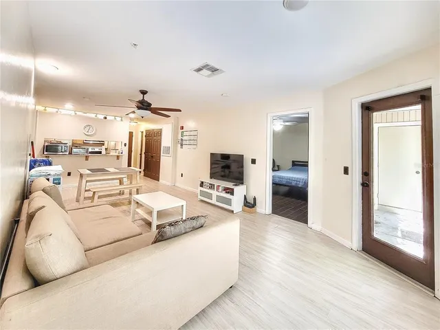 a living room with furniture and wooden floor