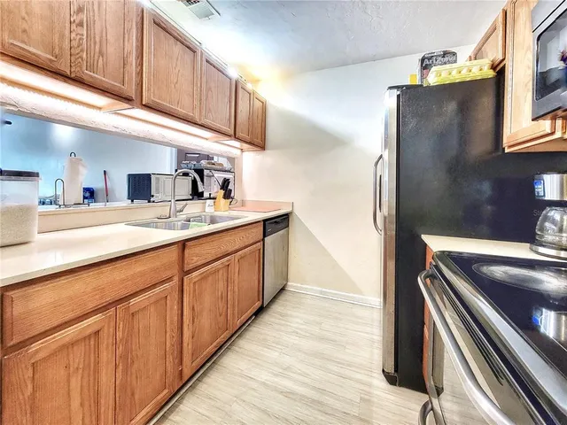 a kitchen with stainless steel appliances granite countertop a stove and a microwave