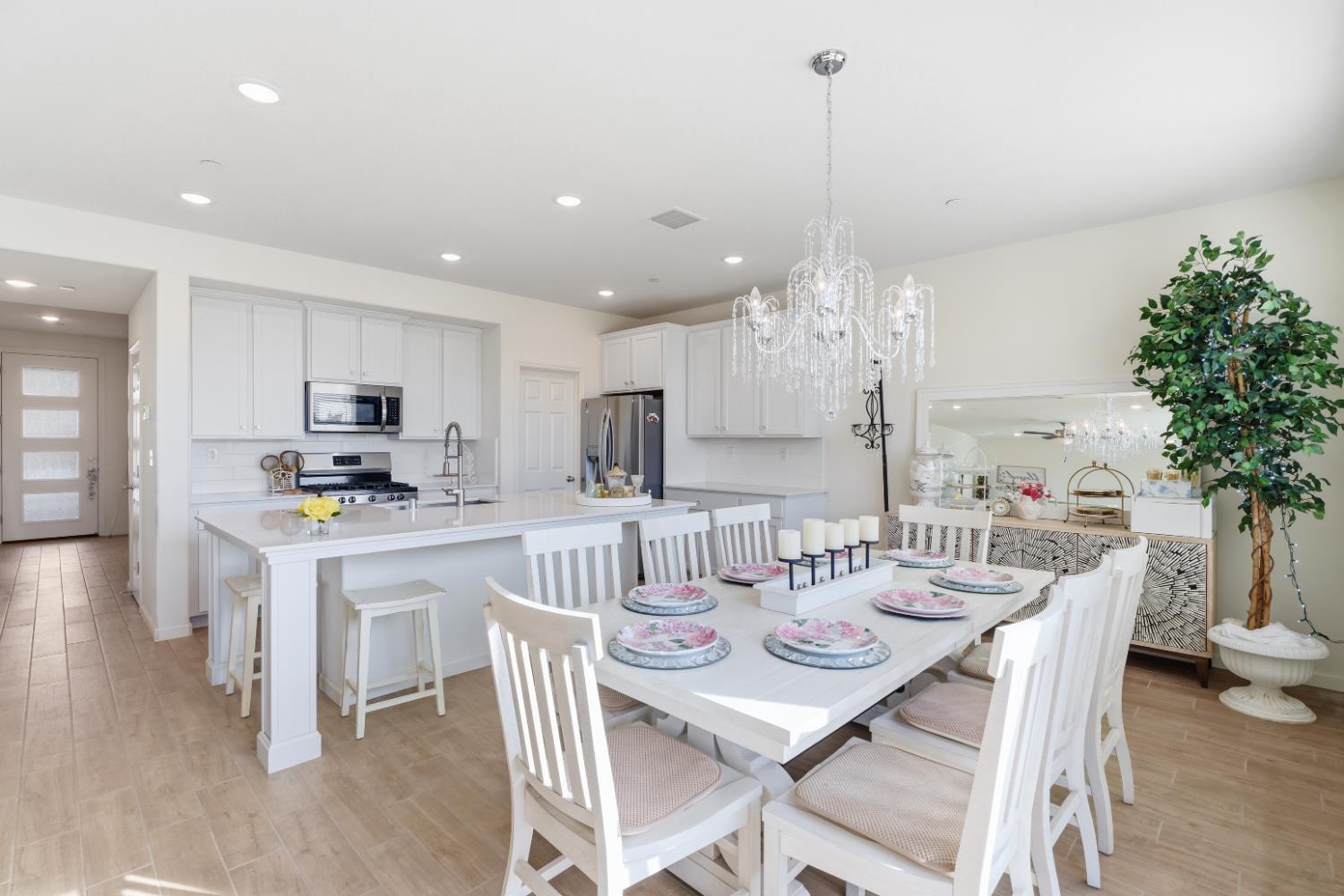 1617 North Filbert Avenue Fresno, CA 93727 - Photo 15 of 45 a view of a dining room and livingroom with furniture wooden floor a chandelier