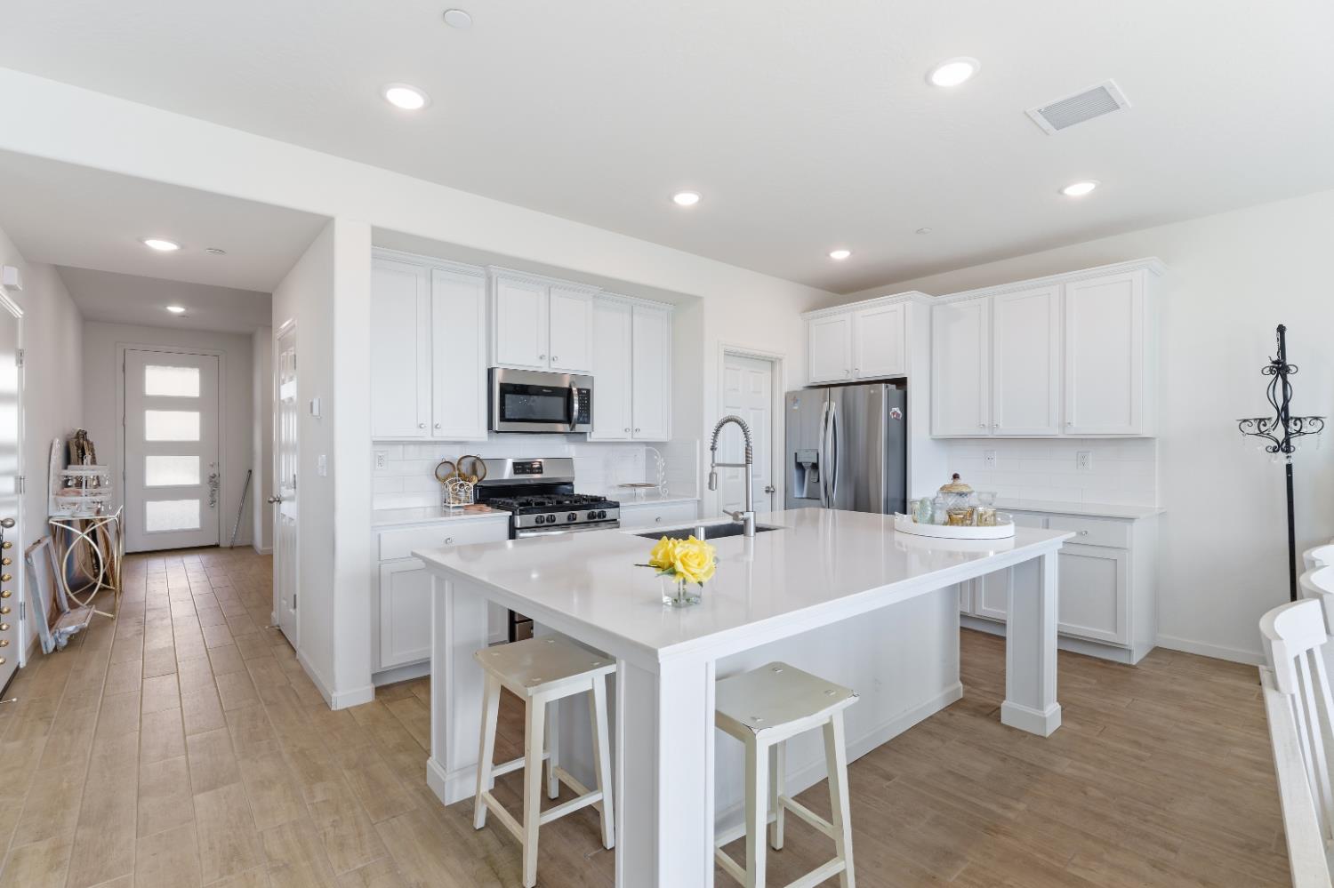 1617 North Filbert Avenue Fresno, CA 93727 - Photo 10 of 45 a kitchen with a sink a center island stainless steel appliances and cabinets