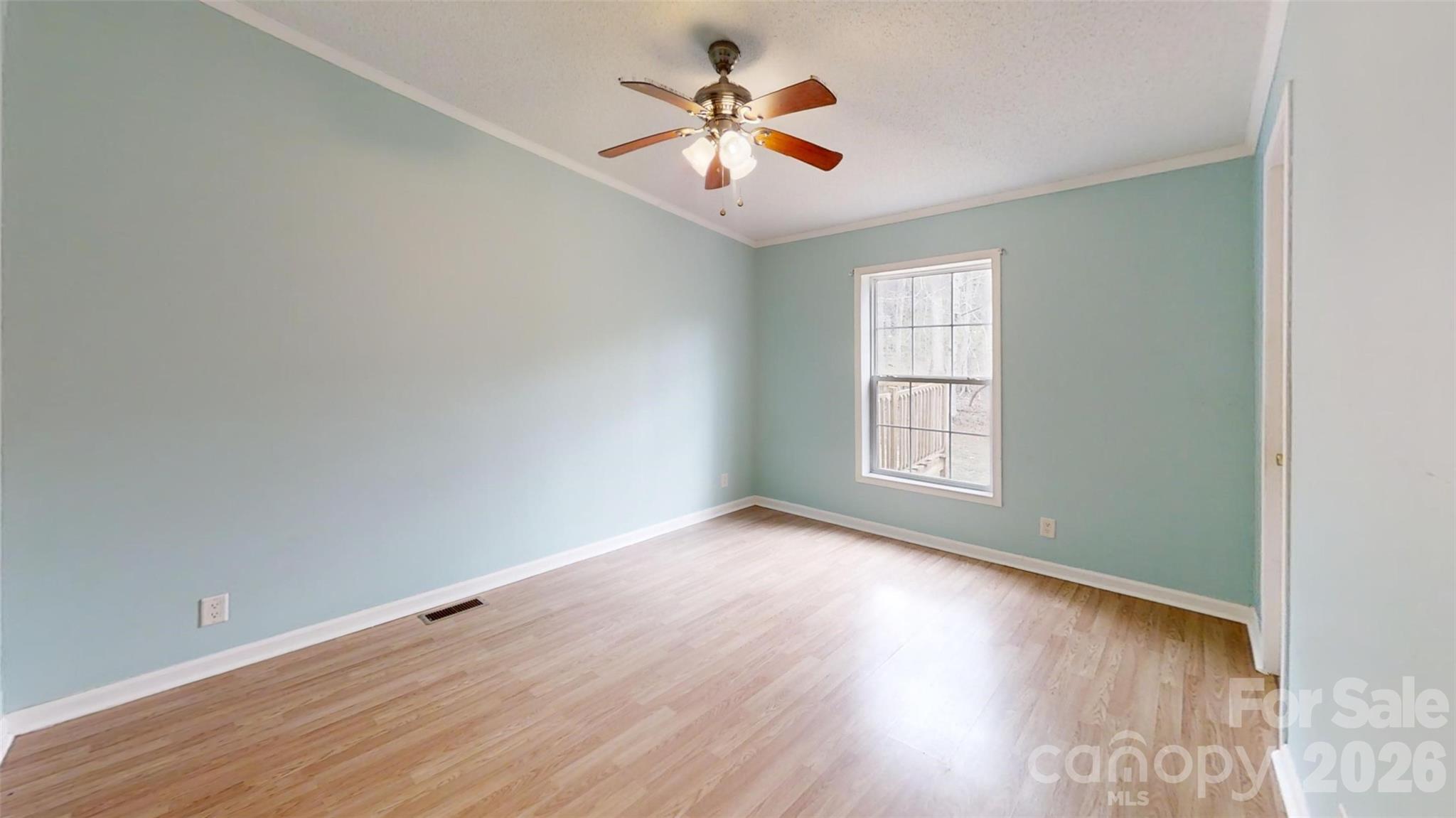 3441 Laboratory Road Lincolnton, NC 28092 - Photo 11 of 24 an empty room with wooden floor and windows