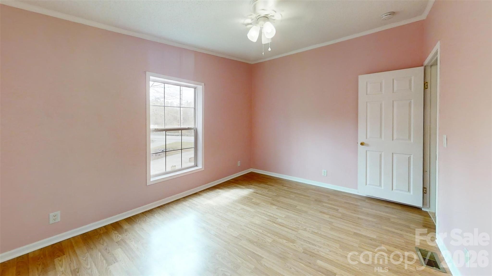 3441 Laboratory Road Lincolnton, NC 28092 - Photo 13 of 24 an empty room with wooden floor chandelier fan and windows