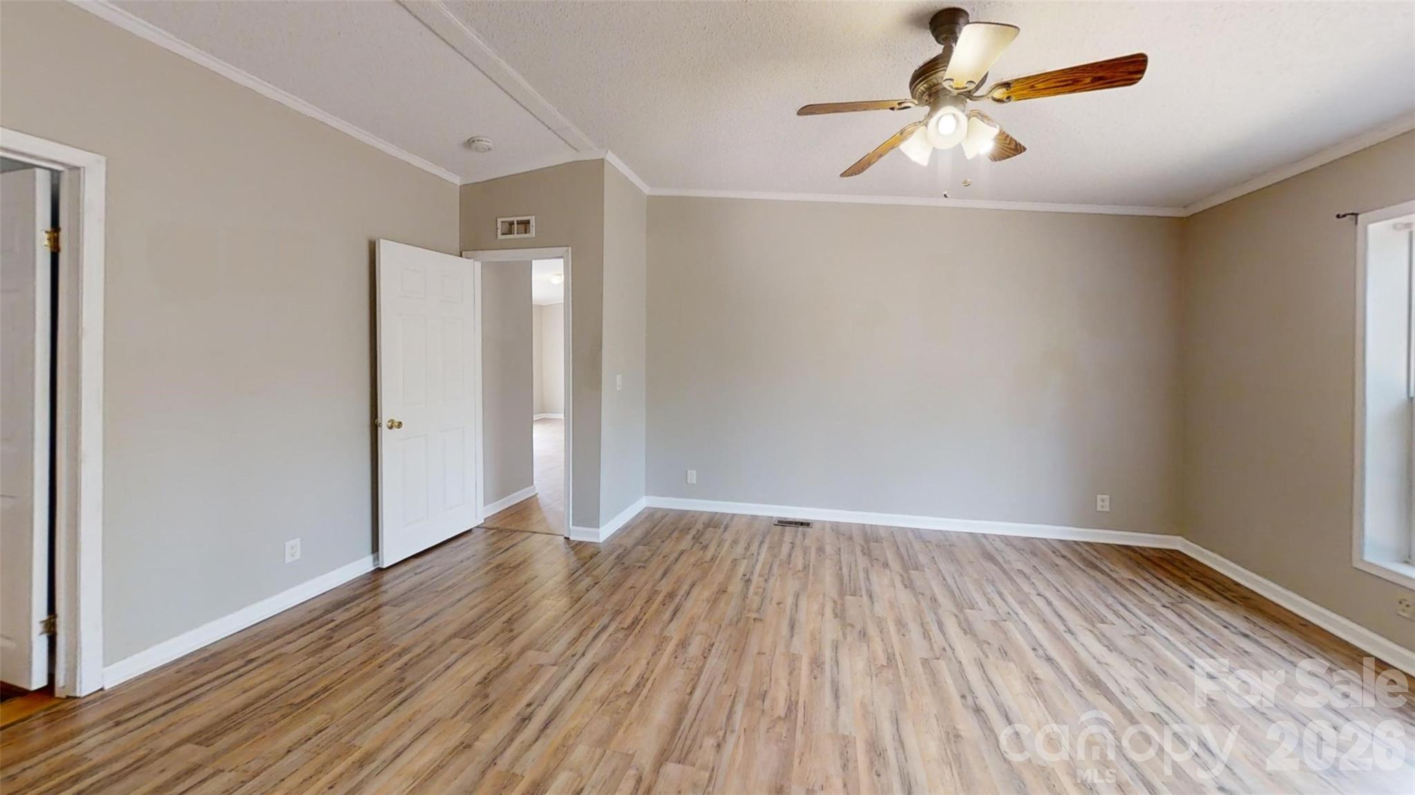 3441 Laboratory Road Lincolnton, NC 28092 - Photo 16 of 24 an empty room with wooden floor fan and windows