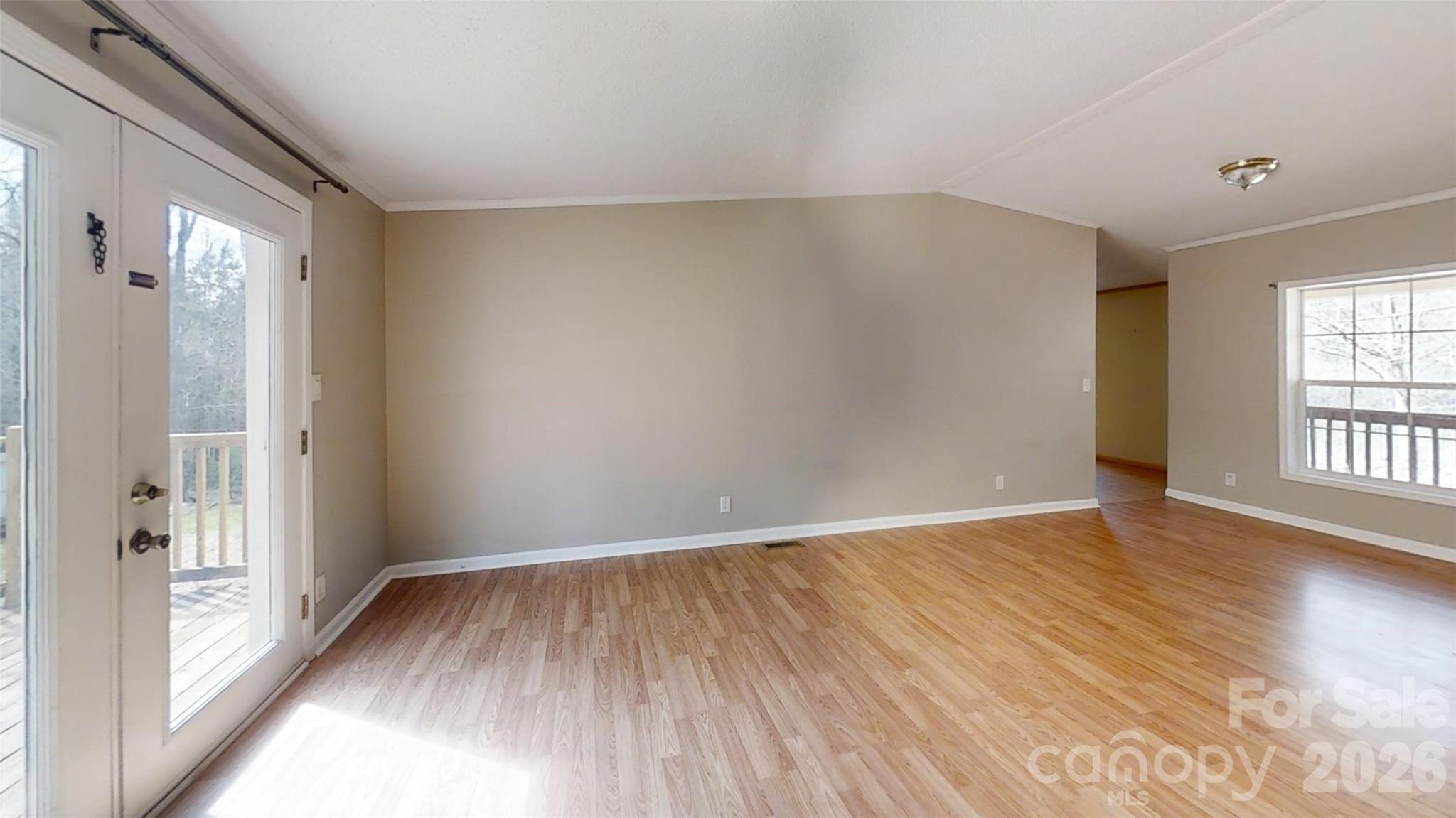3441 Laboratory Road Lincolnton, NC 28092 - Photo 5 of 24 a view of an empty room with wooden floor and a window
