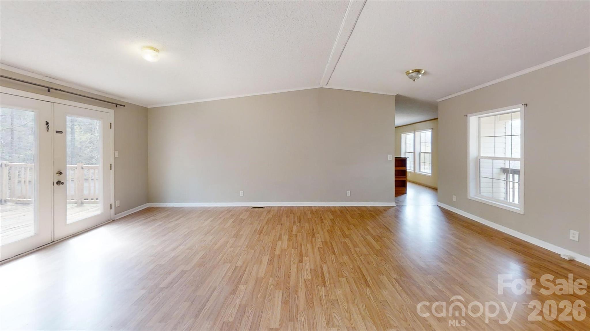 3441 Laboratory Road Lincolnton, NC 28092 - Photo 6 of 24 an empty room with wooden floor and windows