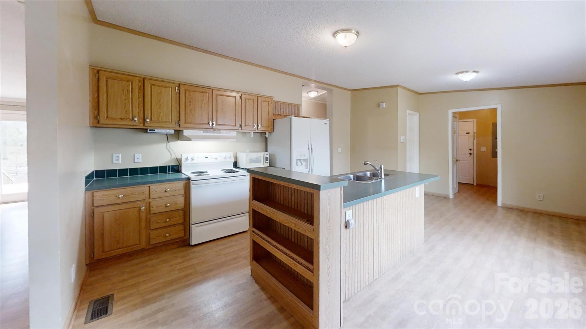 3441 Laboratory Road Lincolnton, NC 28092 - Photo 7 of 24 a kitchen with stainless steel appliances granite countertop a stove and a refrigerator
