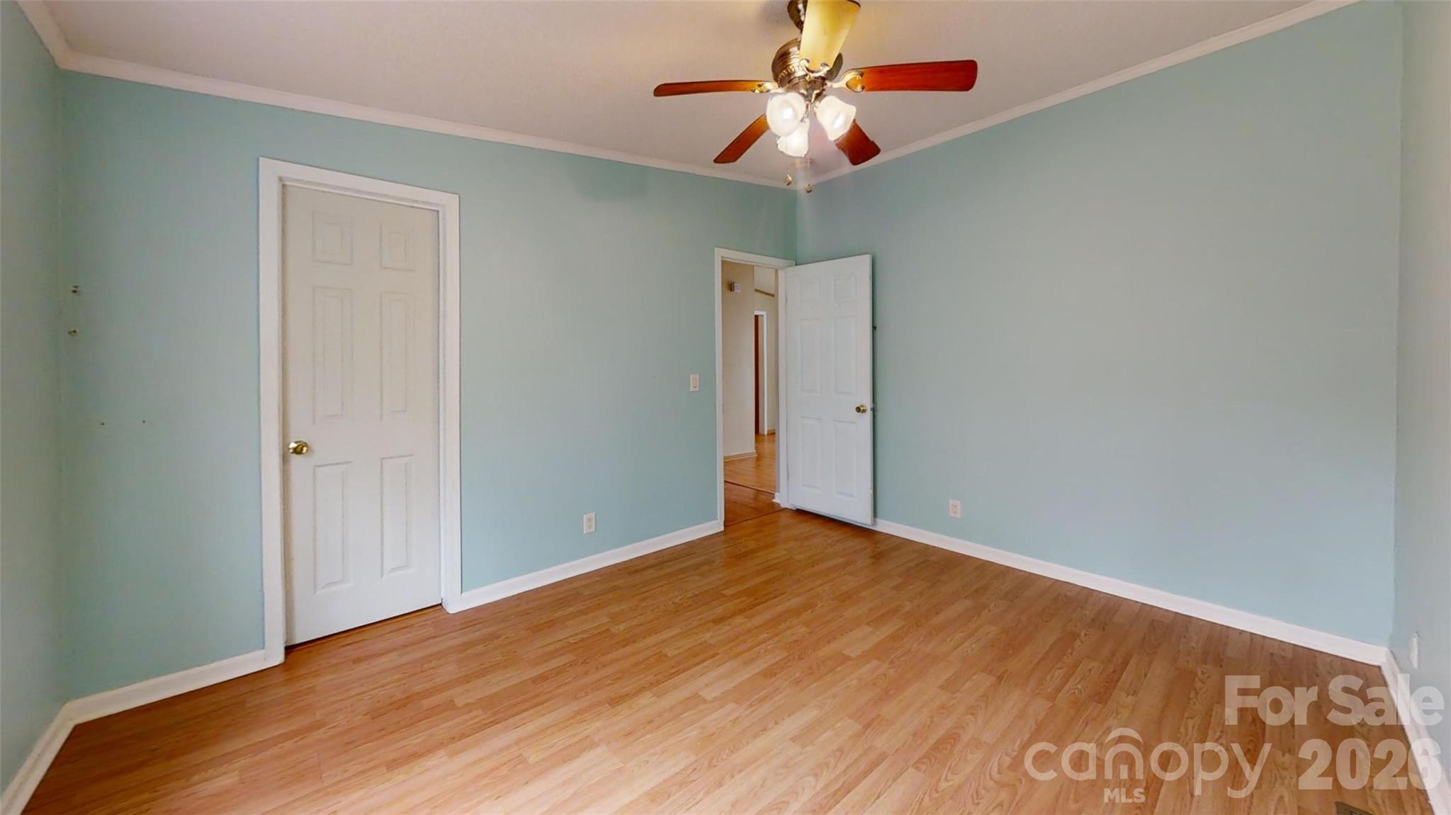 3441 Laboratory Road Lincolnton, NC 28092 - Photo 10 of 24 an empty room with a ceiling fan and wooden floor