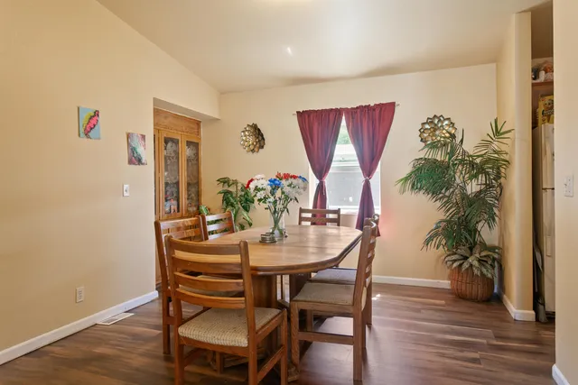 a dining room with furniture and wooden floor
