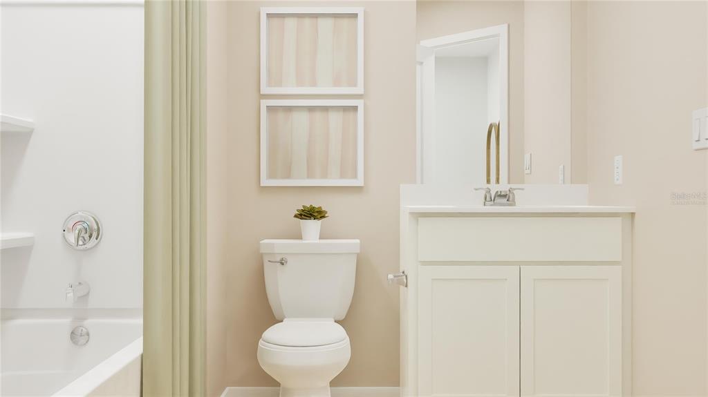 5198 Clay Whaley Road St. Cloud, FL 34772 - Photo 11 of 25 a bathroom with a toilet a sink and a window