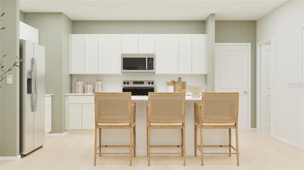 5198 Clay Whaley Road St. Cloud, FL 34772 - Photo 2 of 25 a kitchen with stainless steel appliances a refrigerator and microwave