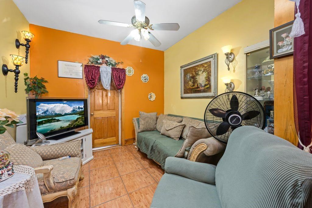 425 36th Street Brooklyn, NY 11232 - Photo 11 of 22 a living room with furniture and a flat screen tv