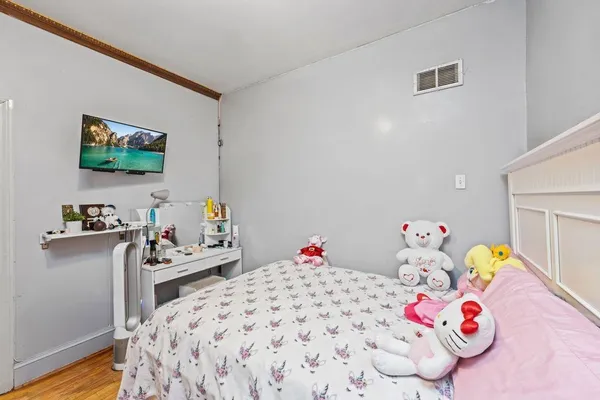 a bedroom with a bed and a tv in it