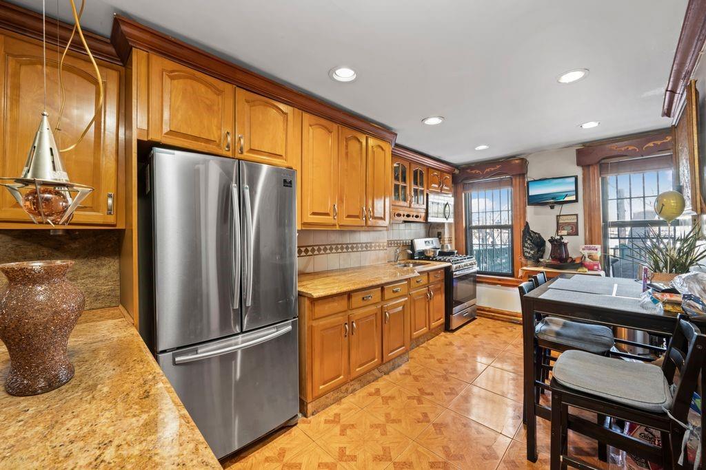 425 36th Street Brooklyn, NY 11232 - Photo 2 of 22 a kitchen with stainless steel appliances granite countertop a refrigerator sink and cabinets