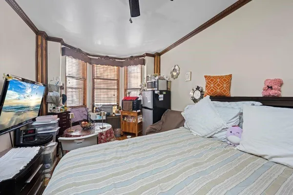 a bedroom with furniture and a flat screen tv