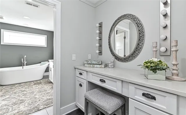 a spacious bathroom with a granite countertop sink and a mirror