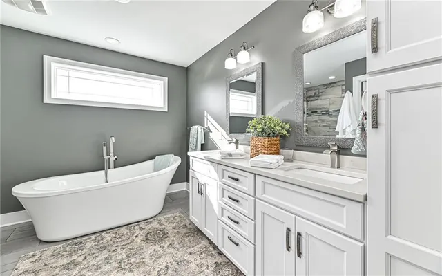 a bathroom with a sink vanity and mirror