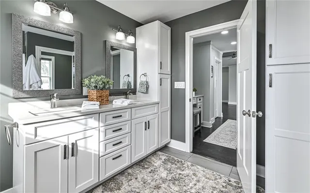a white bath tub sitting next to a white sink