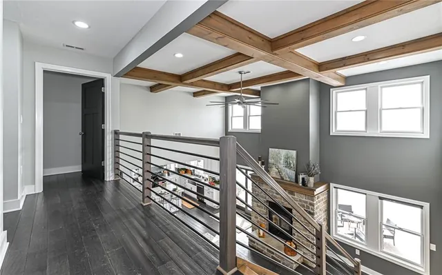 an empty room with windows and ceiling fan